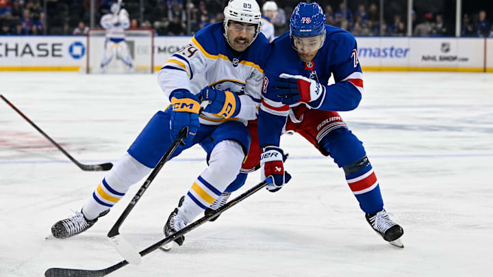 Nov 7, 2024; New York, New York, USA;  Buffalo Sabres right wing Alex Tuch (89) and New York Rangers defenseman K'Andre Miller (79) battle for the puck during the first period at Madison Square Garden. Mandatory Credit: Dennis Schneidler-Imagn Images