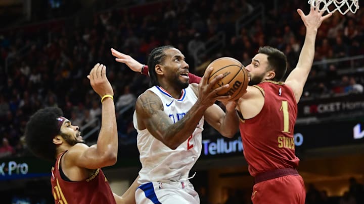 Los Angeles Clippers forward Kawhi Leonard (2) drives to the basket against Cleveland Cavaliers center Jarrett Allen (31) and guard Max Strus (1) during the second half at Rocket Mortgage FieldHouse. Mandatory Credit: Ken Blaze-Imagn Images Los Angeles Clippers forward Kawhi Leonard (2) drives to the basket against Cleveland Cavaliers center Jarrett Allen (31) and guard Max Strus (1) during the second half at Rocket Mortgage FieldHouse. Mandatory Credit: Ken Blaze-Imagn Images
