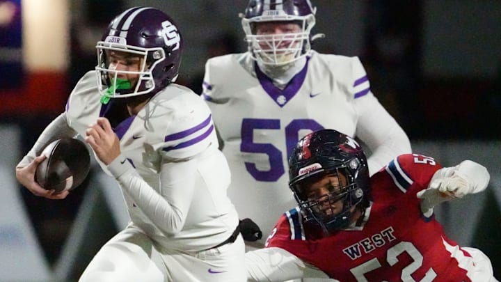 Sevier County's Cooper Newman (7) runs the ball ahead of West's Camarin Leggett (52) during a TSSAA high school football playoff game on Friday, Nov. 22, 2024, in Knoxville, Tenn. Sevier County's Cooper Newman (7) runs the ball ahead of West's Camarin Leggett (52) during a TSSAA high school football playoff game on Friday, Nov. 22, 2024, in Knoxville, Tenn.