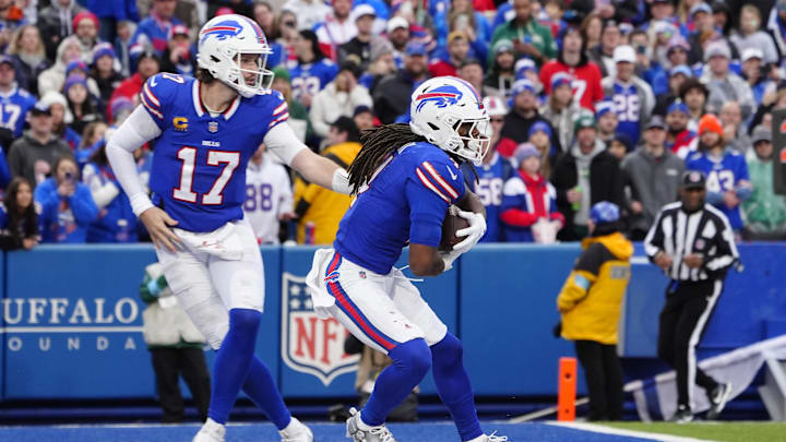 Dec 29, 2024; Orchard Park, New York, USA; Buffalo Bills quarterback Josh Allen (17) hands off the ball to Buffalo Bills running back James Cook (4) during the second half at Highmark Stadium. Mandatory Credit: Gregory Fisher-Imagn Images Dec 29, 2024; Orchard Park, New York, USA; Buffalo Bills quarterback Josh Allen (17) hands off the ball to Buffalo Bills running back James Cook (4) during the second half at Highmark Stadium. Mandatory Credit: Gregory Fisher-Imagn Images