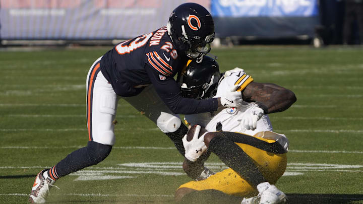 Nov 23, 2025; Chicago, Illinois, USA; Pittsburgh Steelers wide receiver DK Metcalf (4) is tackled by Chicago Bears cornerback Tyrique Stevenson (29) during the first half at Soldier Field. Mandatory Credit: David Banks-Imagn Images