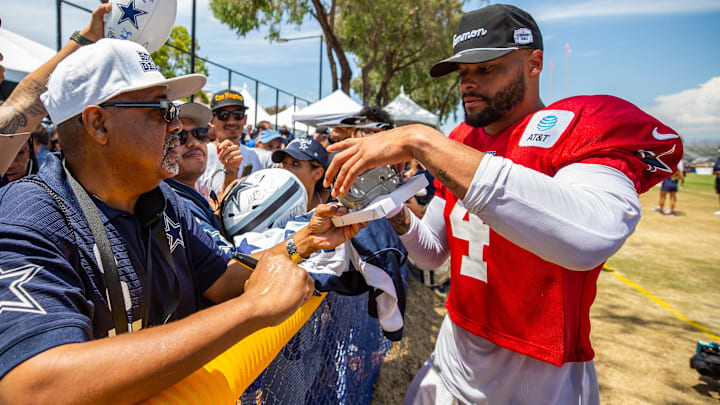 Aug 4, 2022; Oxnard, CA, USA; Dallas Cowboys quarterback Dak Prescott (4) signs autographs during