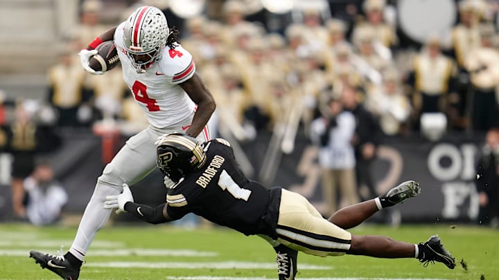 Ohio State Buckeyes wide receiver Jeremiah Smith (4) runs over Purdue Boilermakers defensive back Smiley Bradford (1) during the NCAA football game at Ross-Ade Stadium in West Lafayette, Ind. on Nov. 8, 2025.