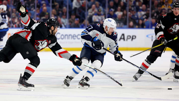 Mar 3, 2024; Buffalo, New York, USA;  Buffalo Sabres right wing Alex Tuch (89) tries to knock the puck off the stick of Winnipeg Jets left wing Nikolaj Ehlers (27) during the first period at KeyBank Center. Mandatory Credit: Timothy T. Ludwig-Imagn Images