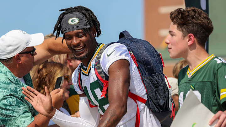 Green Bay Packers wide receiver Malik Heath (18) shares a laugh with the boy whose bike he is riding to practice last year. Green Bay Packers wide receiver Malik Heath (18) shares a laugh with the boy whose bike he is riding to practice last year.