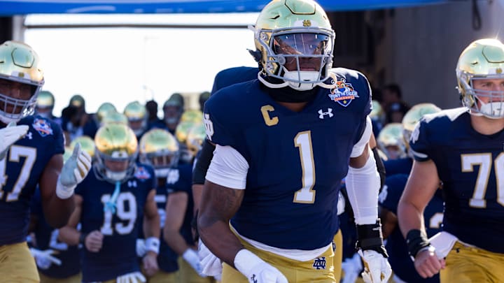 Notre Dame football players take the field before facing Oregon State at the 90th Annual Sun Bowl