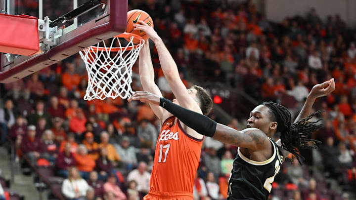 Feb 21, 2026; Blacksburg, Virginia, USA;  Virginia Tech Hokies guard Neoklis Avdalas (17) dunks the ball defended by Wake Forest Demon Deacons forward Tre'von Spillers (25) during the second half at Cassell Coliseum. Mandatory Credit: Brian Bishop-Imagn Images