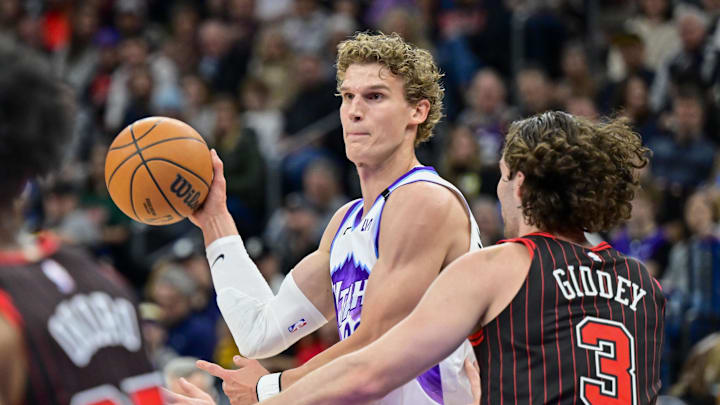 Nov 16, 2025; Salt Lake City, Utah, USA; Utah Jazz forward/center Lauri Markkanen (23) makes a pass around Chicago Bulls guard Josh Giddey (3) during the first half at Delta Center. Mandatory Credit: Peter Creveling-Imagn Images