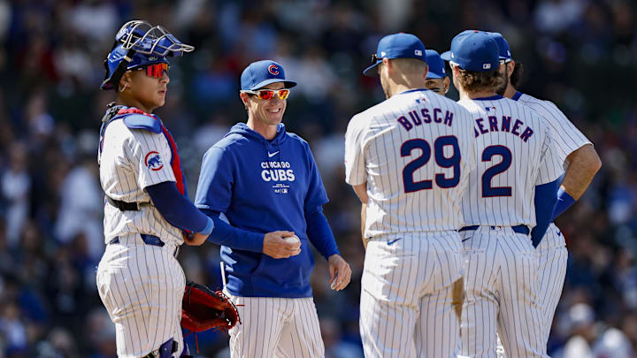 May 3, 2024; Chicago, Illinois, USA; Chicago Cubs manager Craig Counsell (2-L) chats with his players during a pitching change during the eight inning of a baseball game against the Milwaukee Brewers at Wrigley Field.