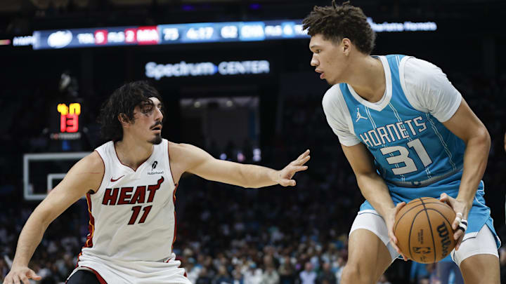 Oct 26, 2024; Charlotte, North Carolina, USA; Charlotte Hornets forward Tidjane Salaun (31) looks to pass against Miami Heat guard Jaime Jaquez Jr. (11) during the second half at Spectrum Center. Mandatory Credit: Nell Redmond-Imagn Images