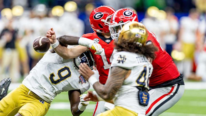 Notre Dame Fighting Irish defensive lineman RJ Oben (9) knocks the ball loose from Georgia Bulldogs quarterback Gunner Stockton (14) for a fumble recovered by Notre Dame Fighting Irish defensive lineman Junior Tuihalamaka (44) during the first half at Caesars Superdome. Notre Dame Fighting Irish defensive lineman RJ Oben (9) knocks the ball loose from Georgia Bulldogs quarterback Gunner Stockton (14) for a fumble recovered by Notre Dame Fighting Irish defensive lineman Junior Tuihalamaka (44) during the first half at Caesars Superdome.