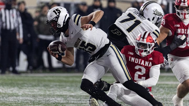 Nov 30, 2024; Bloomington, Indiana, USA; Purdue Boilermakers quarterback Ryan Browne (15) runs the ball while Indiana Hoosiers linebacker Jailin Walker (2) defends in the second half at Memorial Stadium. Mandatory Credit: Trevor Ruszkowski-Imagn Images