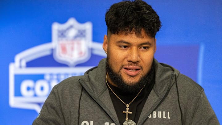 Mar 2, 2024; Indianapolis, IN, USA; Washington offensive lineman Troy Fautanu (OL19) talks to the