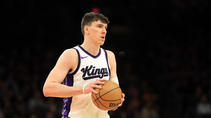 Mar 14, 2025; Phoenix, Arizona, USA; Sacramento Kings forward Jake LaRavia (33) against the Phoenix Suns at Footprint Center. Mandatory Credit: Mark J. Rebilas-Imagn Images
