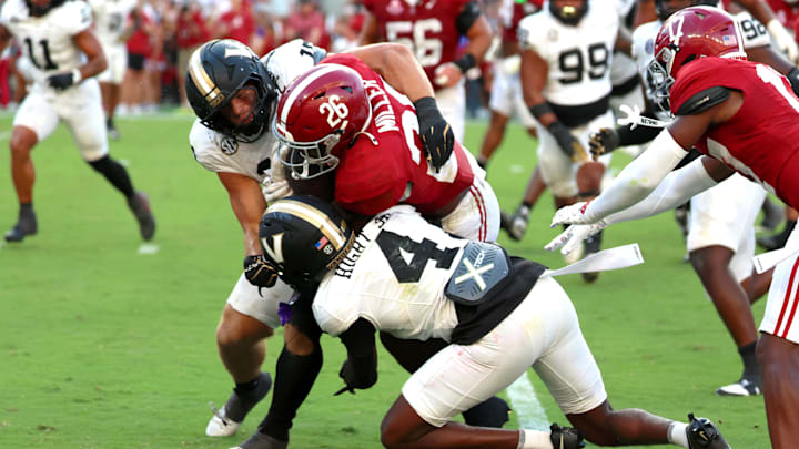Oct 4, 2025; Tuscaloosa, Alabama, USA; Alabama Crimson Tide running back Jam Miller (26) is tacked by Vanderbilt Commodores cornerback Martel Hight (4) during the second half at Saban Field at Bryant-Denny Stadium. Mandatory Credit: David Leong-Imagn Images