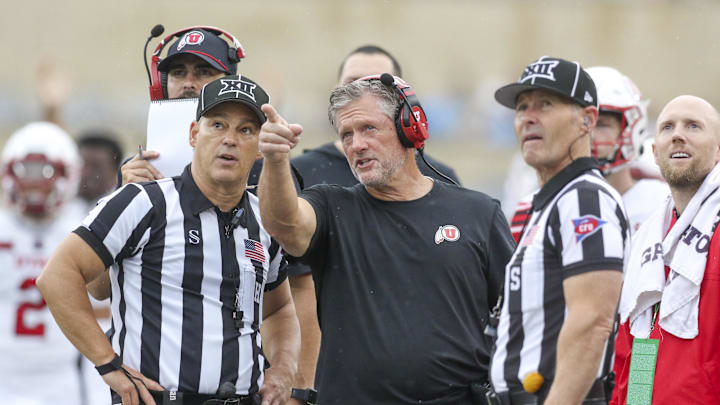 Utah Utes head coach Kyle Whittingham talks to several officials during the third quarter against the West Virginia Mountaineers at Milan Puskar Stadium.