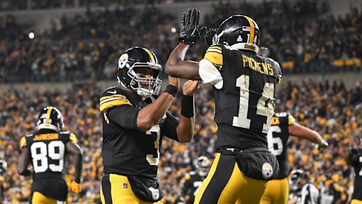 Oct 20, 2024; Pittsburgh, Pennsylvania, USA; Pittsburgh Steelers wide receiver George Pickens (14) celebrates an 11 yard touchdown pass with quarterback Russell Wilson (3) iagainst the New York Jets during the second quarter at Acrisure Stadium. Mandatory Credit: Barry Reeger-Imagn Images