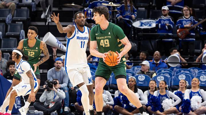 Feb 8, 2026; Memphis, Tennessee, USA; Charlotte 49ers center Anton Bonke (49) handles the ball against Memphis Tigers forward Aaron Bradshaw (11) during the first half at FedExForum. Mandatory Credit: Wesley Hale-Imagn Images