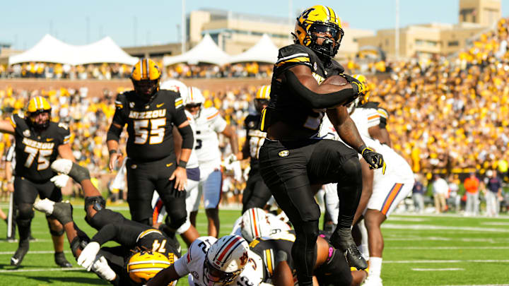 Oct 19, 2024; Columbia, Missouri, USA; Missouri Tigers running back Marcus Carroll (9) scores a touchdown during the second half against the Auburn Tigers at Faurot Field at Memorial Stadium. Mandatory Credit: Jay Biggerstaff-Imagn Images