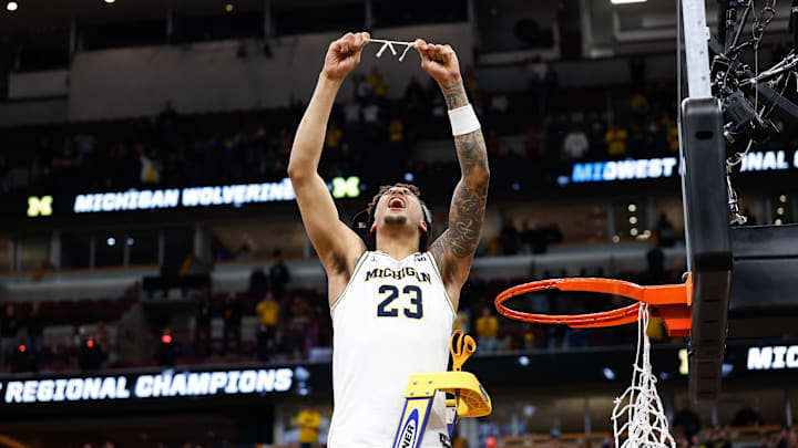 Mar 29, 2026; Chicago, IL, USA; Michigan Wolverines forward Yaxel Lendeborg (23) cuts the net after defeating Tennessee Volunteers in an Elite Eight game of the Midwest Regional of the men's 2026 NCAA Tournament at United Center. Mandatory Credit: Kamil Krzaczynski-Imagn Images