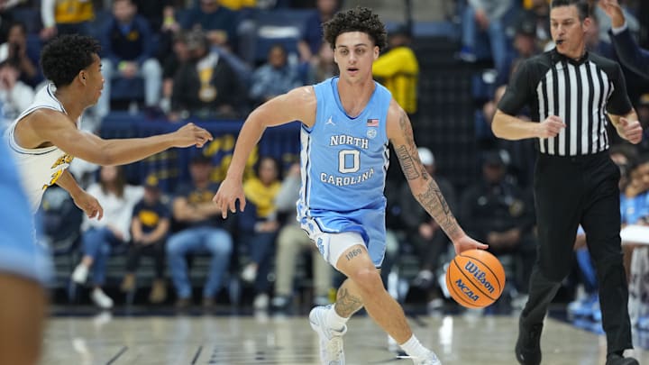 Jan 17, 2026; Berkeley, California, USA; North Carolina Tar Heels guard Kyan Evans (0) dribbles against California Golden Bears guard Semetri (TT) Carr (left) during the first half at Haas Pavilion. Mandatory Credit: Darren Yamashita-Imagn Images
