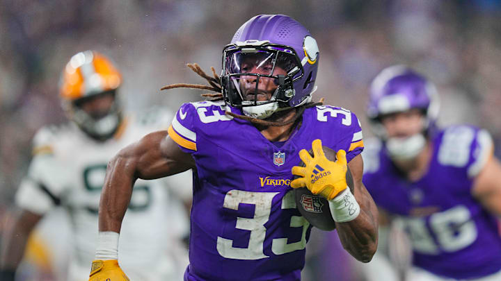 Minnesota Vikings running back Aaron Jones (33) runs with the ball against Green Bay Packers in the third quarter at U.S. Bank Stadium. 