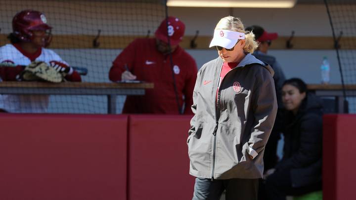 Oklahoma coach Patty Gasso looks down between pitches in a contest against Kentucky.