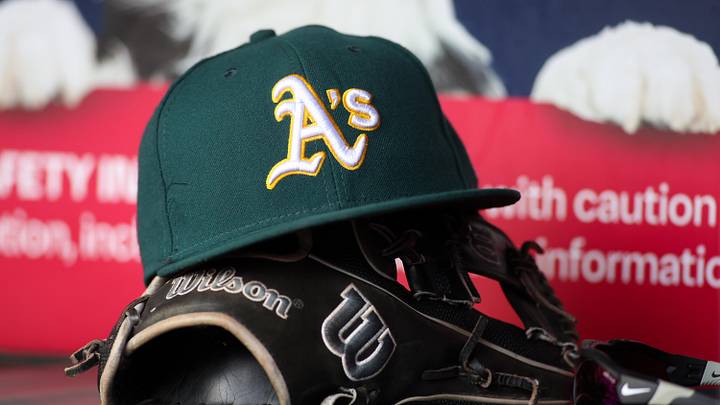 Jun 1, 2024; Atlanta, Georgia, USA; A detailed view of an Oakland Athletics hat and glove on the field against the Atlanta Braves in the sixth inning at Truist Park. Mandatory Credit: Brett Davis-Imagn Images