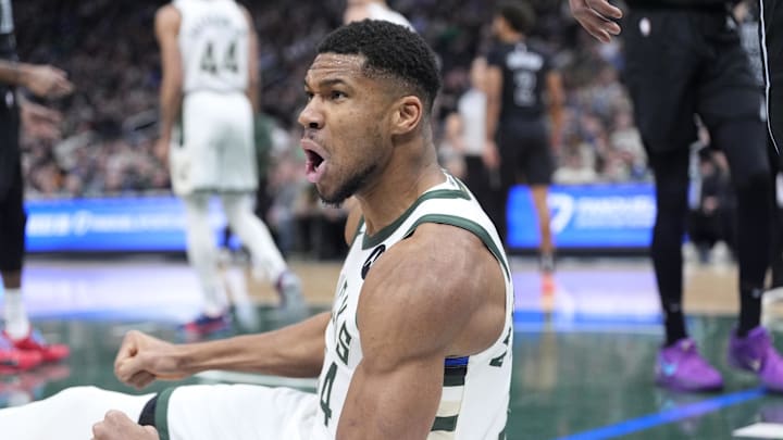 Jan 2, 2025; Milwaukee, Wisconsin, USA; Milwaukee Bucks forward Giannis Antetokounmpo (34) reacts after being fouled driving to the basket against the Brooklyn Nets in the first halfat Fiserv Forum. Mandatory Credit: Michael McLoone-Imagn Images