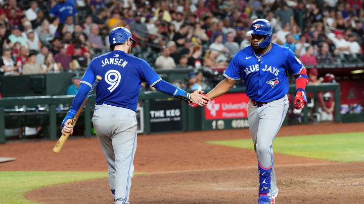 Jul 14, 2024; Phoenix, Arizona, USA; Toronto Blue Jays first base Vladimir Guerrero Jr. (27) slaps hands with Toronto Blue Jays catcher Danny Jansen (9) after hitting a solo home run against the Arizona Diamondbacks during the seventh inning at Chase Field. Jul 14, 2024; Phoenix, Arizona, USA; Toronto Blue Jays first base Vladimir Guerrero Jr. (27) slaps hands with Toronto Blue Jays catcher Danny Jansen (9) after hitting a solo home run against the Arizona Diamondbacks during the seventh inning at Chase Field.