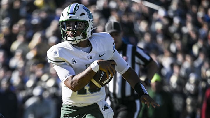 Nov 16, 2024; Annapolis, Maryland, USA;  Tulane Green Wave quarterback Darian Mensah (10) scores a touchdown during the first half against the Navy Midshipmen at Navy-Marine Corps Memorial Stadium. 