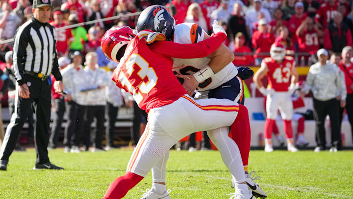 Nov 10, 2024; Kansas City, Missouri, USA; Denver Broncos quarterback Bo Nix (10) is sacked by Kansas City Chiefs safety Nazeeh Johnson (13) during the first half at GEHA Field at Arrowhead Stadium. Mandatory Credit: Denny Medley-Imagn Images