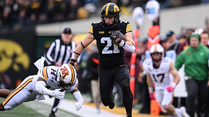 Oct 25, 2025; Iowa City, Iowa, USA; Iowa Hawkeyes wide receiver Kaden Wetjen (21) runs with the ball after a catch against Minnesota Golden Gophers defensive back Kerry Brown (14) during the first quarter at Kinnick Stadium. Mandatory Credit: Jeffrey Becker-Imagn Images Oct 25, 2025; Iowa City, Iowa, USA; Iowa Hawkeyes wide receiver Kaden Wetjen (21) runs with the ball after a catch against Minnesota Golden Gophers defensive back Kerry Brown (14) during the first quarter at Kinnick Stadium. Mandatory Credit: Jeffrey Becker-Imagn Images