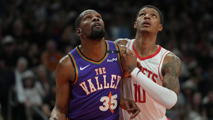 Mar 30, 2025; Phoenix, Arizona, USA; Phoenix Suns forward Kevin Durant (35) and Houston Rockets forward Jabari Smith Jr. (10) fight for position in the first half at Footprint Center. Mandatory Credit: Rick Scuteri-Imagn Images