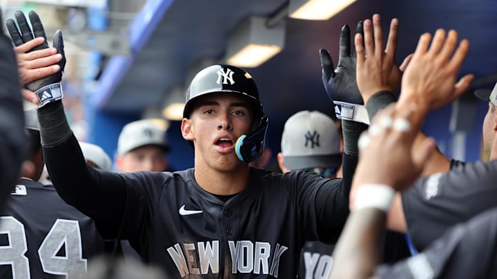 Feb 22, 2025; Dunedin, Florida, USA;  New York Yankees shortstop George Lombard Jr. (96)  is congratulated after he scored a run during the sixth inning against the Toronto Blue Jays at TD Ballpark. Mandatory Credit: Kim Klement Neitzel-Imagn Images