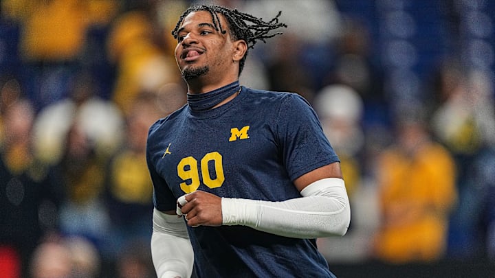 Michigan Wolverines defensive end Aymeric Koumba (90) warms-up on the field Saturday, Dec. 2, 2023, during the game at Lucas Oil Stadium in Indianapolis.