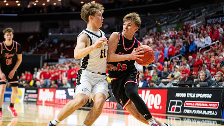ADM's Hudson Lorensen (13) drives past Clear Lake's Trevor Theobald (11) during the Class 3A semifinal on Thursday, March 13, 2025, at Wells Fargo Arena.