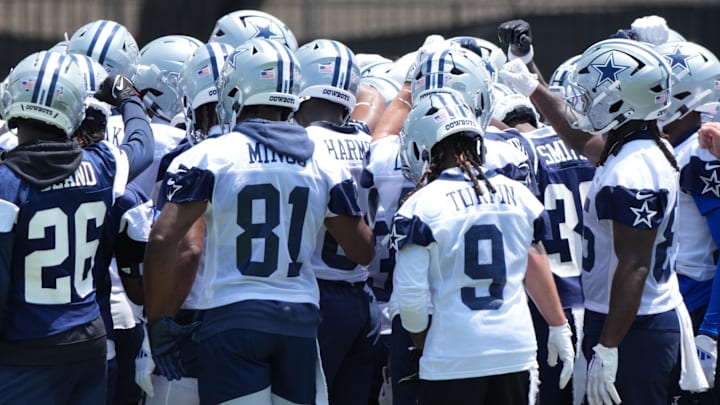 Dallas Cowboys players huddle during training camp at the River Ridge Fields.