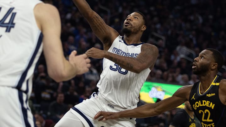 Memphis Grizzlies guard Marcus Smart (36) lays up the ball ahead of Golden State Warriors forward Andrew Wiggins (22) during the first quarter at Chase Center. Mandatory Credit: D. Ross Cameron-Imagn Images