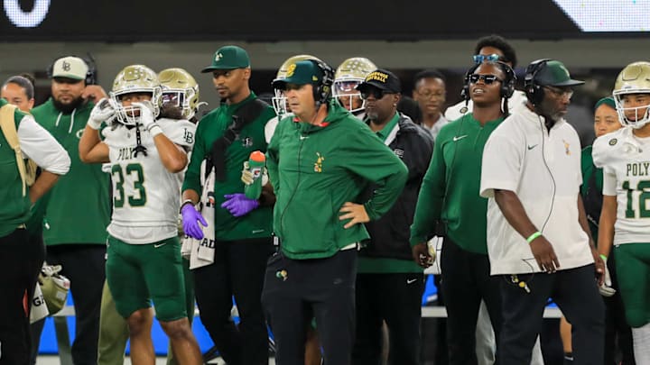 Long Beach Poly football coach Stephen Barbee stands on sideline while coaching against Mission Viejo at SoFi Stadium.
