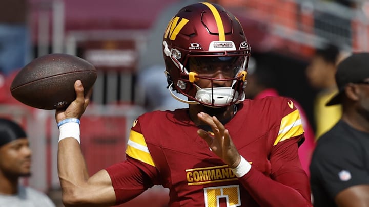 Oct 6, 2024; Landover, Maryland, USA; Washington Commanders quarterback Jayden Daniels (5) passes a ball during warmup prior to the game against the Cleveland Browns at NorthWest Stadium. Mandatory Credit: Geoff Burke-Imagn Images