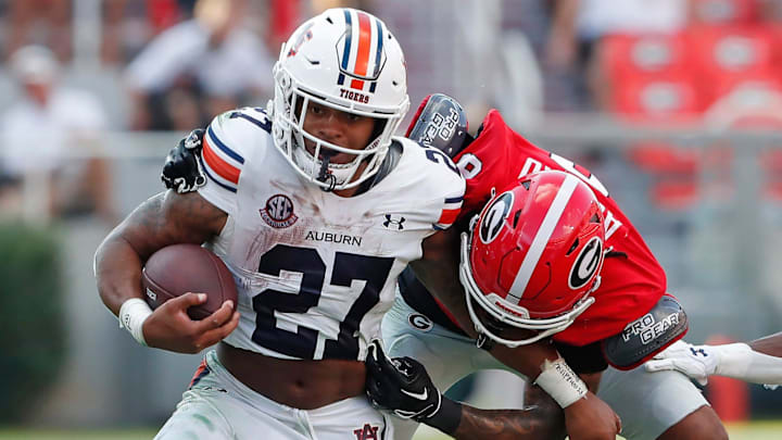 Auburn running back Jarquez Hunter (27) breaks a tackle from Georgia defensive back Joenel Aguero (8) during the second half of a NCAA college football game in Athens, Ga., on Saturday, Oct. 5, 2024. Auburn running back Jarquez Hunter (27) breaks a tackle from Georgia defensive back Joenel Aguero (8) during the second half of a NCAA college football game in Athens, Ga., on Saturday, Oct. 5, 2024.
