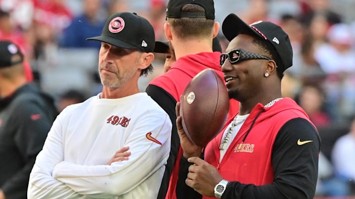 Jan 5, 2025; Glendale, Arizona, USA; San Francisco 49ers head coach Kyle Shanahan (left) and wide receiver Deebo Samuel Sr. (right) look on prior to the game against the Arizona Cardinals at State Farm Stadium. Mandatory Credit: Matt Kartozian-Imagn Images