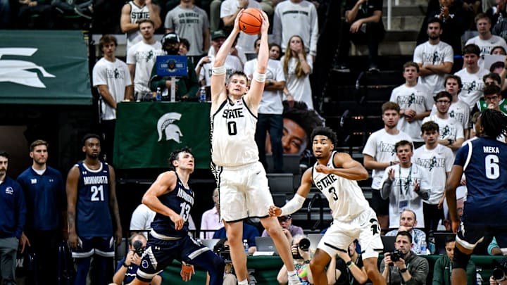 Michigan State's Jaxon Kohler, center, gains possession after blocking Monmouth's Jack Collins, left, during the second half on Monday, Nov. 4, 2024, at the Breslin Center in East Lansing.