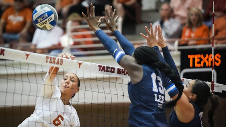 Texas outside hitter Madisen Skinner hits the ball over the net as BYU middle blocker Mia Lee, center, and setter Whitney Bower jump to block in the Longhorns' match against the Cougars, Sept. 28, 2023 in Gregory Gymnasium. Texas dropped the first set to the Cougars, but won the next three for a victory at home in Austin.