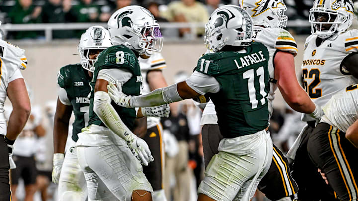 Michigan State's Aisea Moa, left, celebrates with Alessio Anelu Lafaele, right, after a tackle for a loss against Western Michigan's during the fourth quarter on Friday, Aug. 29, 2025, in East Lansing.