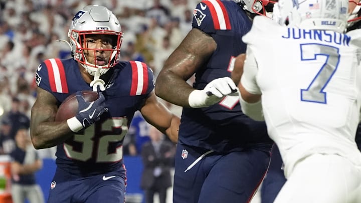 Oct 5, 2025; Orchard Park, New York, USA; New England Patriots running back Treveyon Henderson (32) rushes the ball against the Buffalo Bills during the first half at Highmark Stadium. Mandatory Credit: Gregory Fisher-Imagn Images