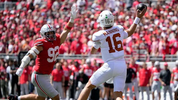 Texas Longhorns quarterback Arch Manning (16) throws the ball against Ohio State Buckeyes defensive end Caden Curry (92)