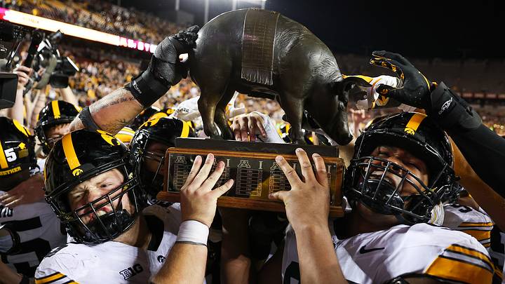 Sep 21, 2024; Minneapolis, Minnesota, USA; Iowa Hawkeyes offensive lineman Logan Jones (65) and defensive lineman Yahya Black (94) celebrate with the Floyd of Rosedale trophy after the game against the Minnesota Golden Gophers at Huntington Bank Stadium.
