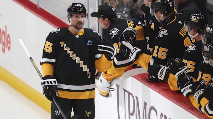 Apr 8, 2025; Pittsburgh, Pennsylvania, USA;  Pittsburgh Penguins defenseman Erik Karlsson (65) celebrates his 200th career NHL goal with the Penguins bench against the Chicago Blackhawks during the second period at PPG Paints Arena. Mandatory Credit: Charles LeClaire-Imagn Images